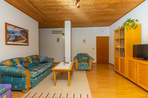 a living room with a couch and a table at Vacattio apartment 2 in Crikvenica