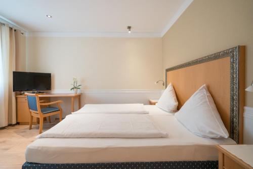 Hotel 'Zum Augarten'にあるベッド