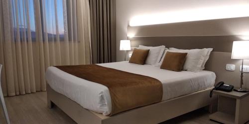 Postel nebo postele na pokoji v ubytování Hotel Glis