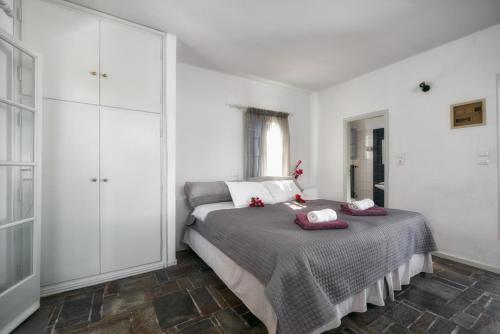 a bedroom with a bed with two pillows on it at Aegean Village in Parikia