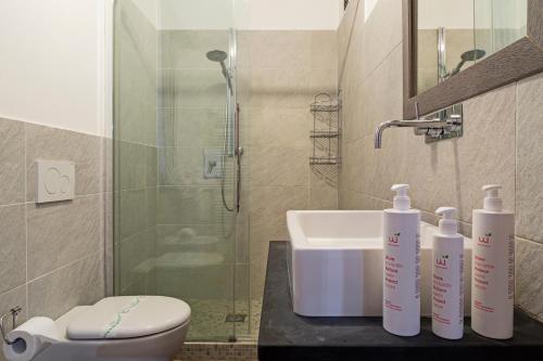 a bathroom with a sink and a toilet and a shower at La Dimora del Ducale by Wonderful Italy in Genoa