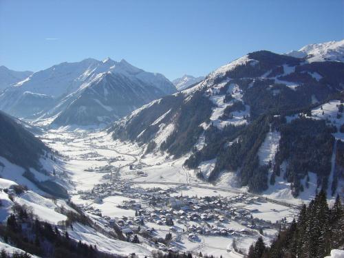 a view of a snowy mountain with a town in a valley at Pension und Appartement Weinschreiber in Rauris