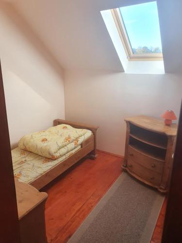 a bedroom with a bed and a desk and a window at Silentium Clavem Domus III. in Odorheiu Secuiesc