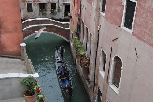 a group of people in a boat in a canal at Ruzzini Palace Hotel in Venice