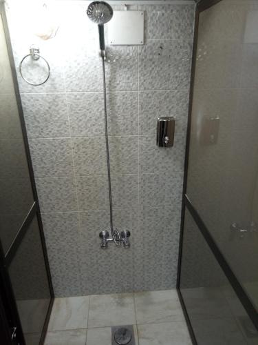 a shower with a glass door in a bathroom at Happy Night Hostel in Wadi Musa