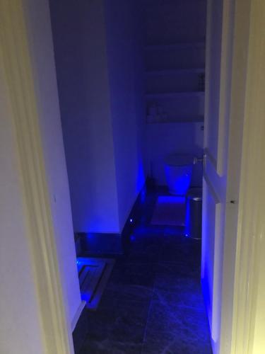 a hallway with a blue light in a room at 2 Bedroom Apartment close to Camden Town in London