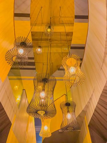 a group of chandeliers hanging from a ceiling at The Twizt - Lifestyle Hostel & Hotel in Siem Reap