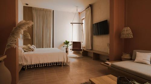 a hotel room with a bed and a couch at Casa Montore by Barrio Mexico in Guadalajara
