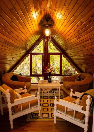 a room with a large window in a tree house at Eren Villa in Sapanca