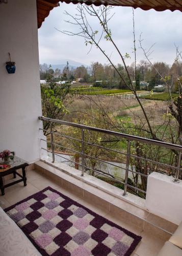a room with a balcony with a view of a field at Eren Villa in Sapanca