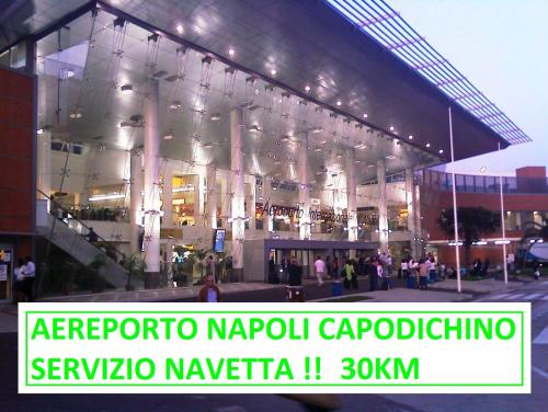 a large building with people standing outside of it at Tufaro B&B Private Room in Macerata Campania