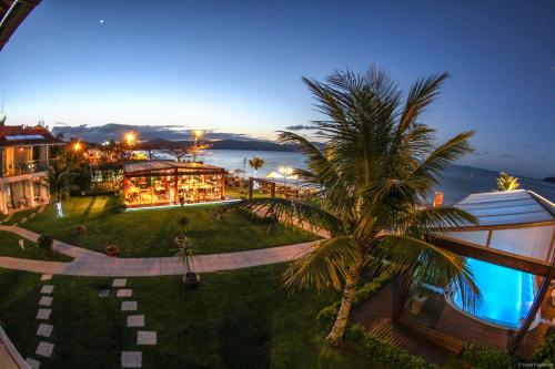 an aerial view of a resort with a palm tree at Hotel Sete Ilhas in Florianópolis