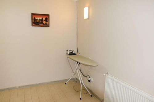 a room with a desk and a painting on the wall at Gostynniy Dvir Hostel in Ternopil