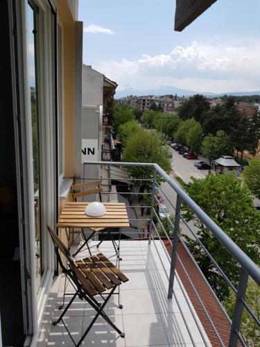 a balcony with a table and chairs on it at City Life Apartments #1 in Ioannina