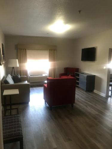 a living room with a couch and a tv at Comfort Suites Shenandoah-The Woodlands in The Woodlands