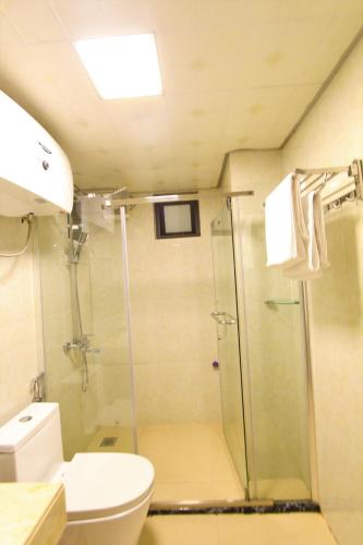 a bathroom with a shower and a toilet and a sink at Himalaya Sapa Hotel in Sa Pa