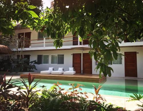 a house with a swimming pool in front of it at AGAM Hotel Boutique Bacalar - Adults Only in Bacalar
