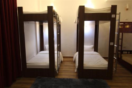 a room with two bunk beds and two mirrors at Himalaya Sapa Hotel in Sa Pa