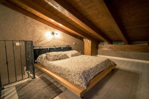 a bedroom with a large bed in a attic at TENUTA I TUFARI in Tivoli