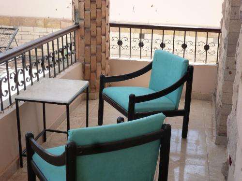 two chairs and a table on a balcony at DREAM ISLAND Hotel in Luxor