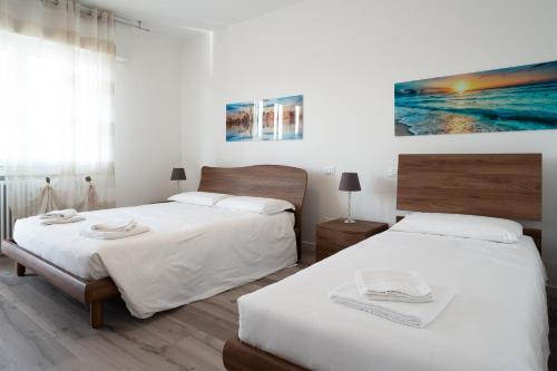 - une chambre avec 2 lits et un tableau mural dans l'établissement Residenza Conte Manetti, à Mira