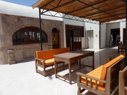a patio with a table and benches and a building at DREAM ISLAND Hotel in Luxor
