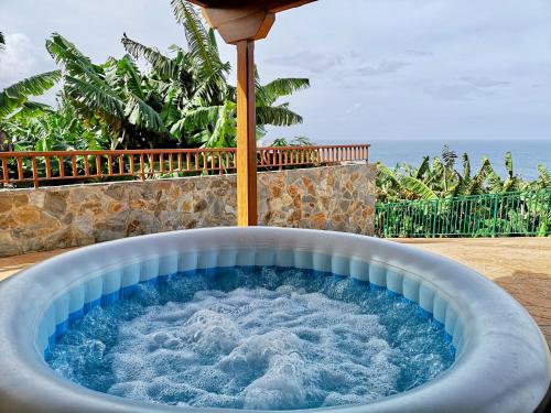 a hot tub with water in it on a patio at Banana Paradise in La Orotava