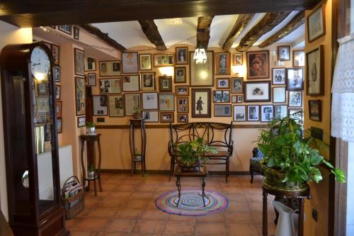 a room with a bunch of pictures on the wall at Hostal Santa Agueda in Tarazona de Aragón