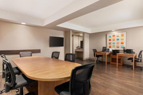 an office with a conference room with tables and chairs at Royal Hotel Calgary, Trademark Collection by Wyndham in Calgary