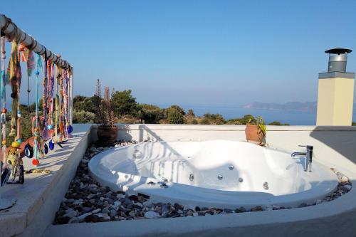 a bath tub sitting on the side of a building at Mandarin & Mango Boutique Hotel in Faralya