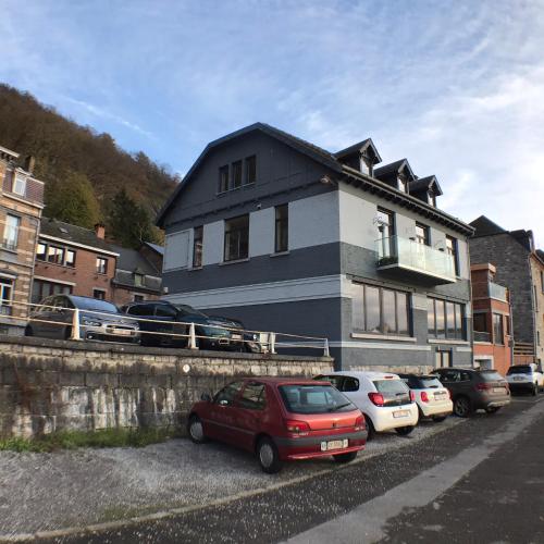 a red car parked in front of a house at Les rives de Sax in Dinant