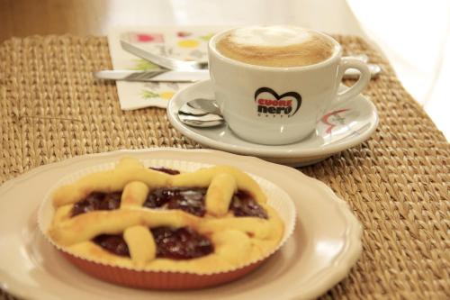 a cup of coffee and a pastry on a table at Peperosa in collina B&B in Pescara