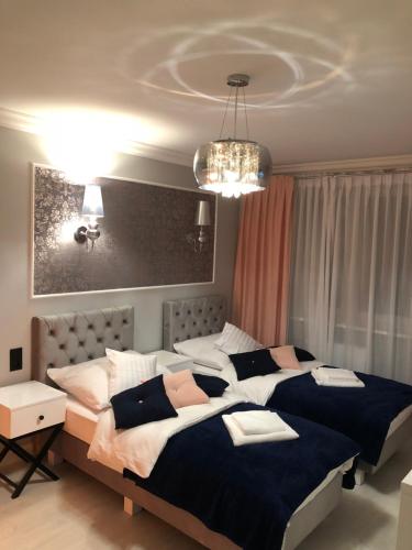 Posteľ alebo postele v izbe v ubytovaní Apartament Luksusowy z sauną
