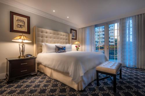 a bedroom with a large bed and a window at Beverly Hills Plaza Hotel & Spa in Los Angeles