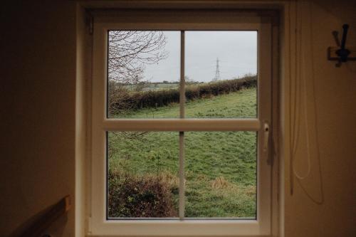 a view of a field through a window at Betty's Loft in Lisburn