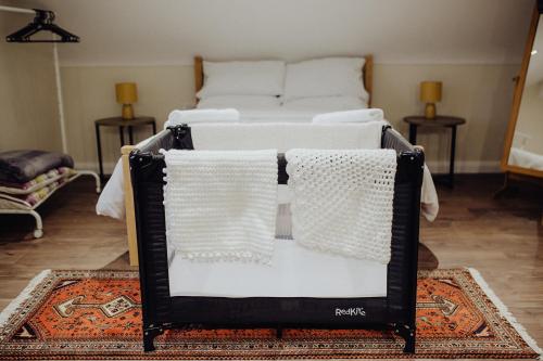 a bed with white pillows on it in a room at Betty's Loft in Lisburn