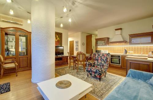 a kitchen and living room with a table and chairs at Helios 19 Luxury Vilnius Apartment in Vilnius