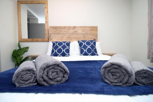 a bedroom with a bed with towels on it at 3BR Home with Parking in Swansea in Swansea