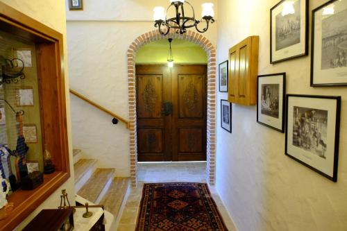 a hallway with an archway leading to a wooden door at Mandarin & Mango Boutique Hotel in Faralya