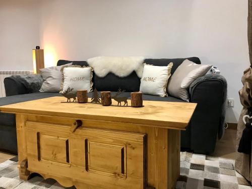 a living room with a couch and a wooden coffee table at Vall del Riu - Llar dolça llar HUT07815 in Soldeu