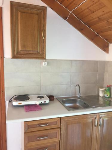 a kitchen counter with a sink and a stove at Belvedere Zakynthos Studios in Vasilikos
