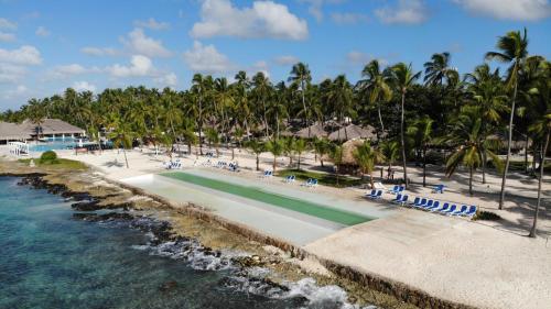 a swimming pool at a resort next to the water at Viva Dominicus Beach by Wyndham, A Trademark All Inclusive in Bayahibe