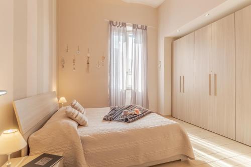 a bedroom with a bed and a large window at La Casa Rosa in Terni