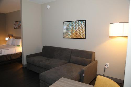 a living room with a couch and a bed at La Quinta by Wyndham Montgomery in Montgomery
