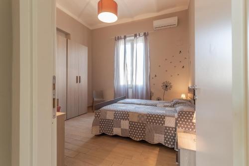a bedroom with a bed and a window at La Casa Rosa in Terni
