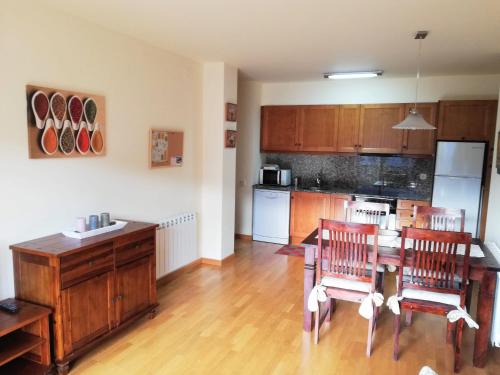 a kitchen with a table and chairs in a room at APARTAMENT CA DE GALLISCA B 4PAX in Pla de l'Ermita