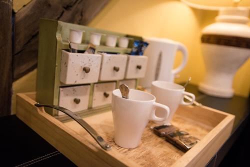a wooden tray with two cups on a table at The Royal Arms Hotel in Sutton Cheney
