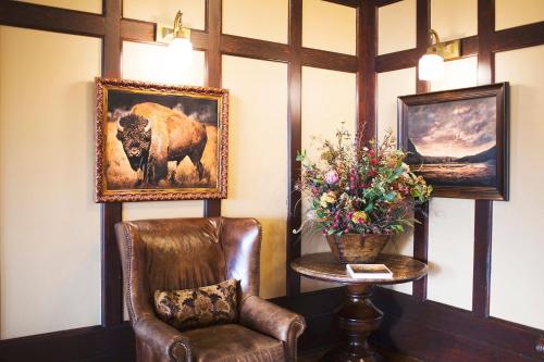 a living room with a painting of a dog on the wall at The Sacajawea Hotel in Three Forks