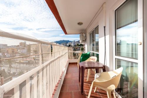 a balcony with chairs and a table and a view at Apartamento Diana ii in Benalmádena