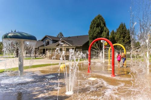 two children playing in a fountain in a park at Eagle Crest Nature Retreat in Redmond